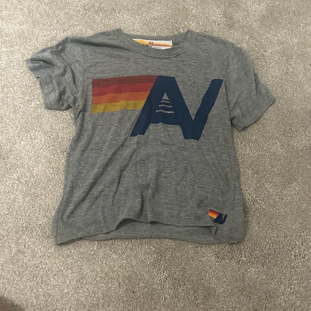 gray avatar nation shirt. with sing. super cute. size xs. worn with care.